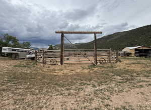 View of yard featuring an exterior structure, a mountain view, an outbuilding, and a rural view