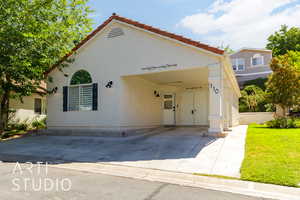 Mediterranean / spanish home featuring stucco siding and a front lawn