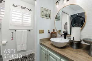 Bathroom with washer / clothes dryer and vanity
