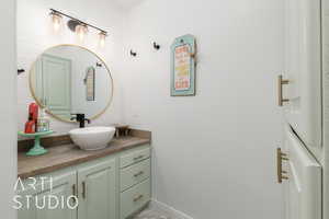 Bathroom with vanity and baseboards