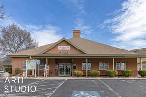 View of property with uncovered parking