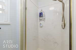 Bathroom featuring a marble finish shower