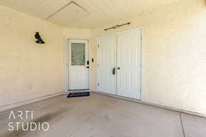 Doorway to property featuring stucco siding
