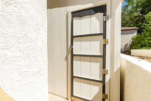 Doorway to property featuring stucco siding