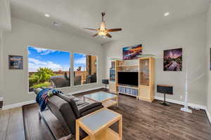 Living area with wood finished floors, ceiling fan, and recessed lighting