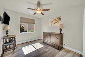 Bedroom with baseboards and wood finished floors
