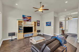 Living area with dark wood-style flooring, ceiling fan, and recessed lighting