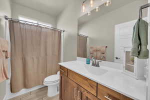 Full bath featuring vanity, shower / bath combination with curtain, and wood finished floors