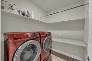 Washroom with independent washer and dryer and baseboards