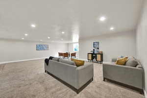 Living area featuring recessed lighting and light carpet