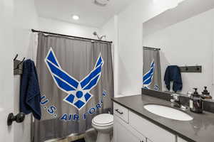 Full bathroom with vanity, a shower with shower curtain, and wood finished floors