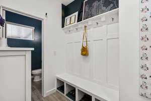 Mudroom featuring wood finished floors and baseboards