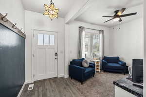 Entrance foyer with dark wood-style flooring and a ceiling fan