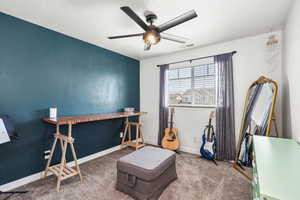 Misc room featuring a ceiling fan and carpet floors