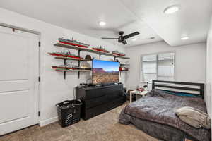 Carpeted bedroom featuring a textured ceiling, recessed lighting, and ceiling fan
