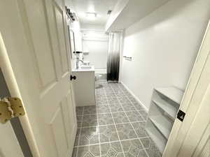 Bathroom with vanity and shower / bath combination with curtain