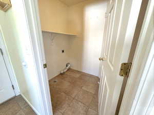 Washroom featuring electric dryer hookup and baseboards