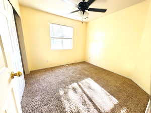 Unfurnished bedroom featuring carpet, a closet, and ceiling fan