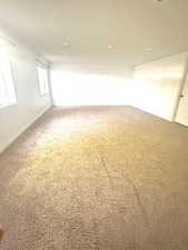 Carpeted empty room with baseboards