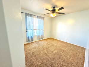 Unfurnished room with carpet and ceiling fan