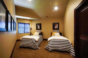 Bedroom featuring carpet flooring and lofted ceiling