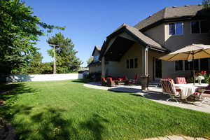 Back of house featuring stucco siding, a patio area, entry steps, and roof with shingles