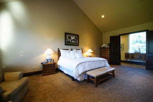 Bedroom with carpet flooring, high vaulted ceiling, and recessed lighting