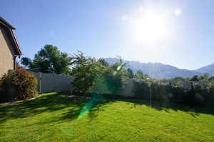 Fenced backyard featuring a mountain view