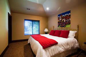Carpeted bedroom featuring baseboards
