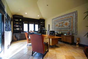 Office space with vaulted ceiling and recessed lighting