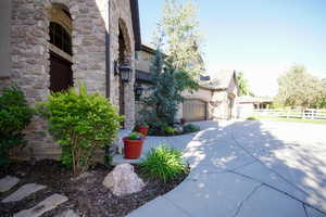 View of property exterior with stone siding and driveway