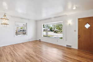 Entrance foyer with light wood-type flooring and baseboards
