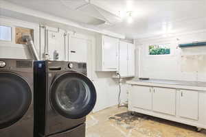 Laundry area with washer and clothes dryer and cabinet space