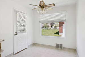 Dining area with door that leads to rear patio.