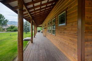 Wooden deck with a yard and a mountain view