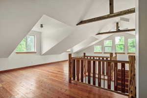 Additional living space featuring hardwood / wood-style flooring and a ceiling fan