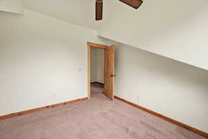 Spare room featuring light carpet and ceiling fan