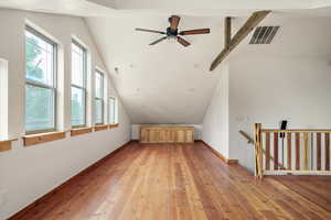 Additional living space featuring lofted ceiling, light wood-type flooring, and ceiling fan