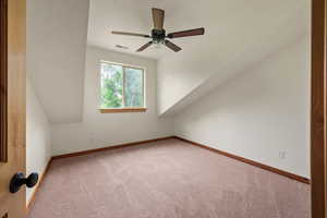 Additional living space with carpet and ceiling fan