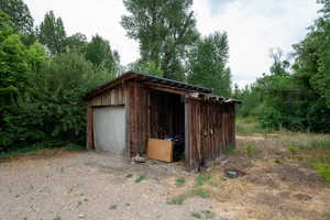 View of outdoor structure featuring driveway