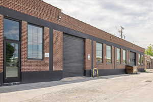 View of building exterior with an attached garage