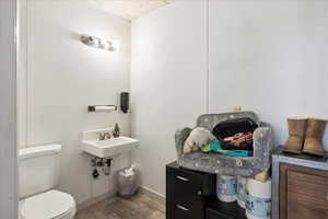 Half bath with wood finished floors and a paneled ceiling