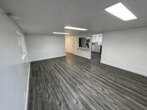 Unfurnished living room featuring dark wood finished floors