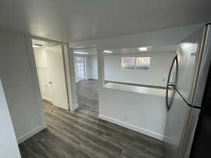 Kitchen featuring freestanding refrigerator and dark wood-style flooring