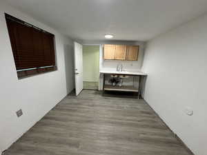 Bar area with wood finished floors and a textured ceiling