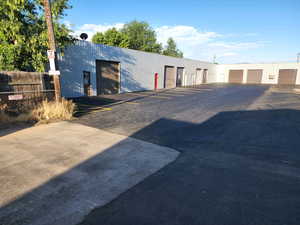 View of outbuilding featuring community garages