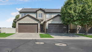 View of front of home with board and batten siding and concrete driveway