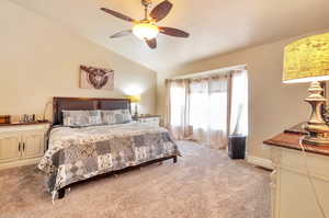 Bedroom with light carpet, lofted ceiling, and ceiling fan