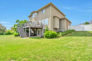 Back of property with a gate, stucco siding, a deck, stairs, and a patio