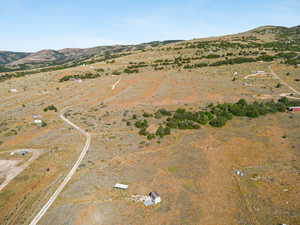 Aerial view of property and surrounding area with a mountainous background and rural landscape